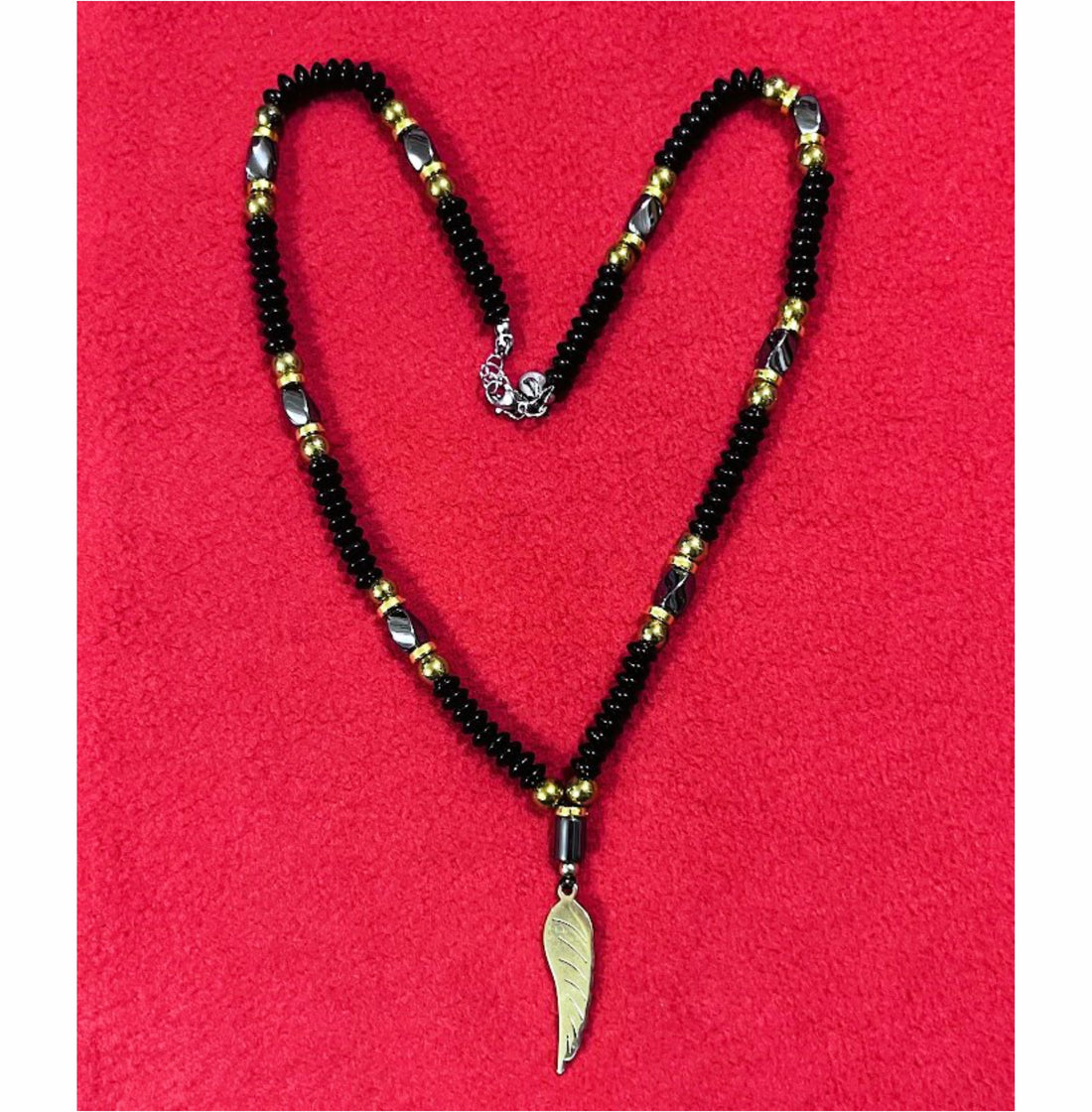 Handcrafted Black Beaded Necklace with Gold Accents and Feather Pendant for Men
